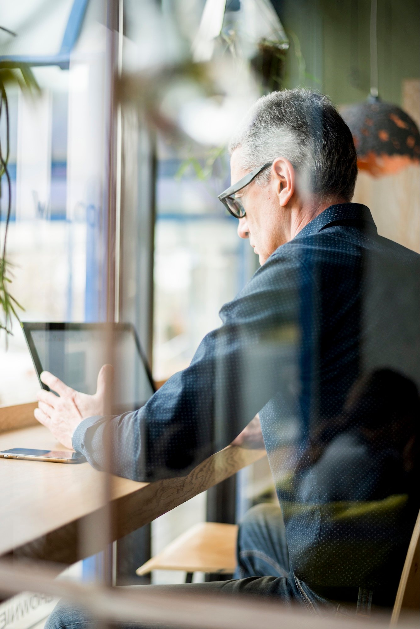 elderly-businessman-through-shop-window